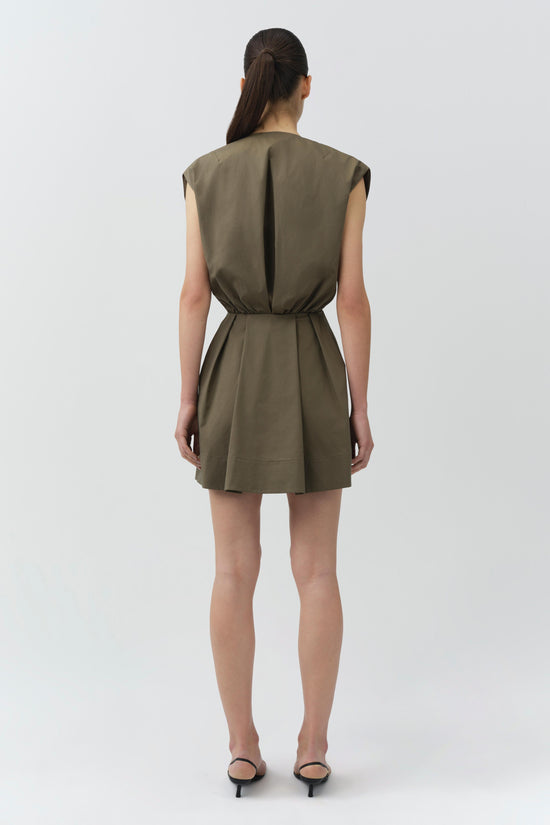 Olive cotton cape mini dress with sleeveless design and cinched waist, shown from back view.