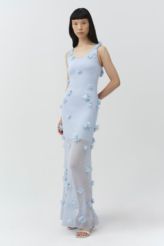 Light blue sleeveless midi dress with three-dimensional floral appliqués throughout and ruffled neckline.