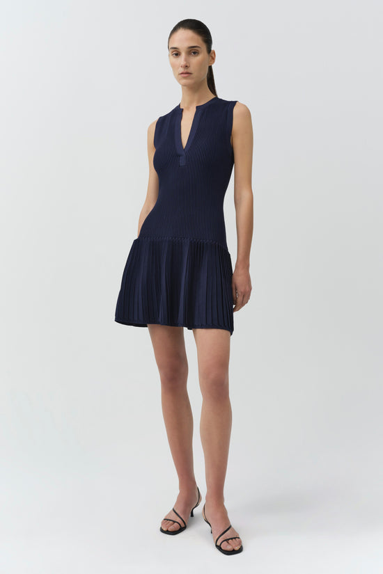 Navy ribbed knit sleeveless mini dress with drop waist and pleated skirt hem.