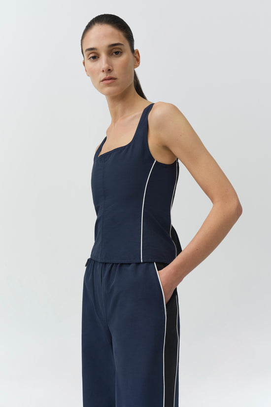 Navy cotton faille bustier top with square neckline, front zip closure, and white piping detail on sleeves and sides.