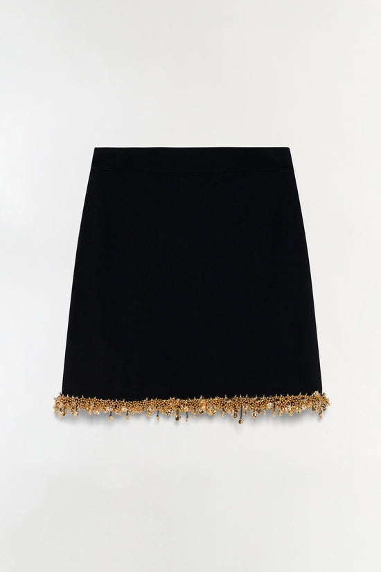 Black knit mini skirt with gold beaded trim along the hem.