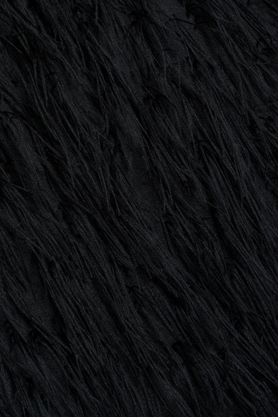 Black jacquard fabric with diagonal texture and fringe detail.
