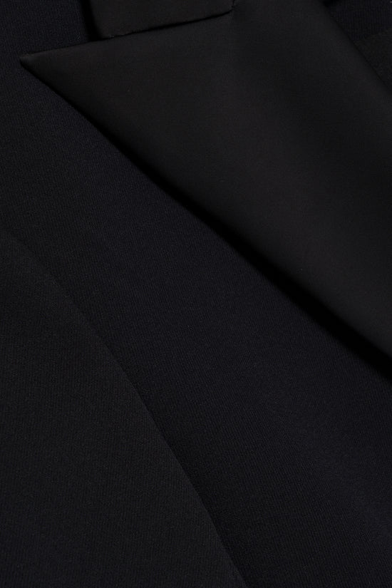 Black blazer mini dress with structured tailoring and diagonal seam details.