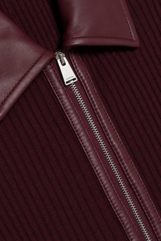 Burgundy knit midi dress with leather panel detail and silver metal zipper closure.