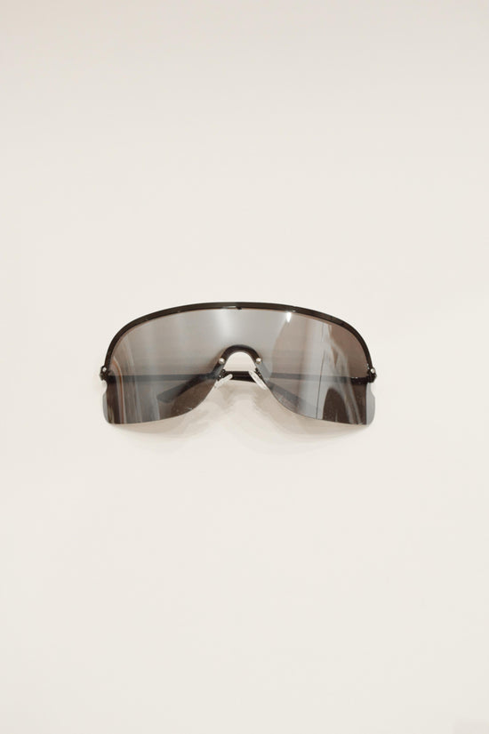 Oversized sunglasses with dark tinted gradient lenses and thin black metal frame with nose bridge.