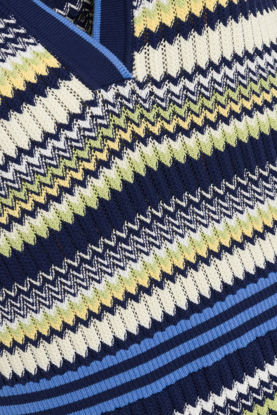 Navy knit dress with geometric houndstooth pattern in cream, yellow, and lime green with blue ribbed trim.