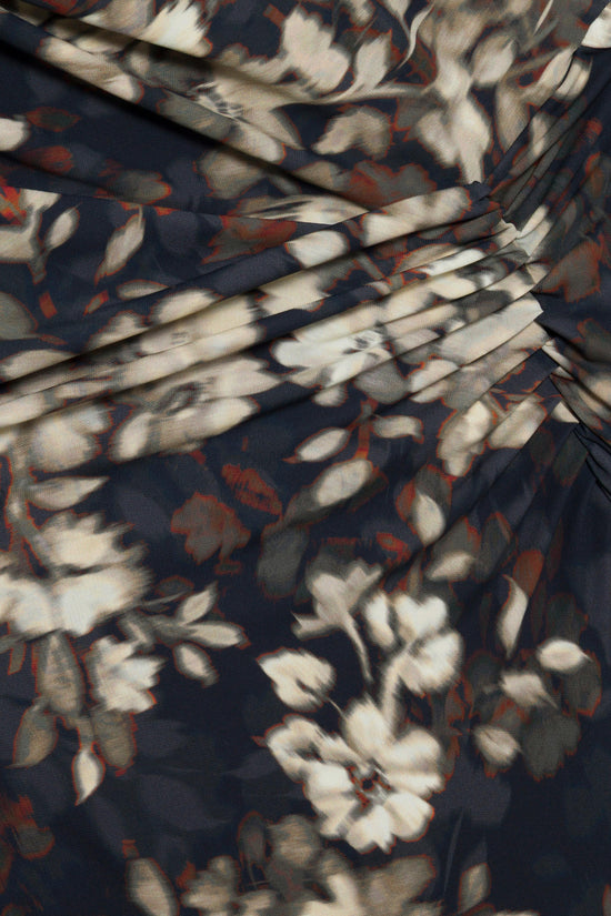 Navy jersey dress with cream and rust floral print, featuring draped fabric detail at the bodice.