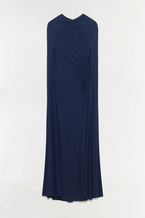 Navy blue draped jersey gown with cape overlay and ruched side detail.