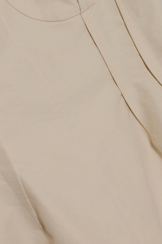Beige cotton faille bustier top with curved seaming detail and rounded neckline.