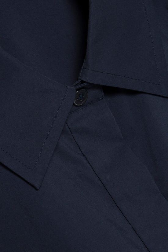 Navy cotton shirt with button front closure and pointed collar detail.