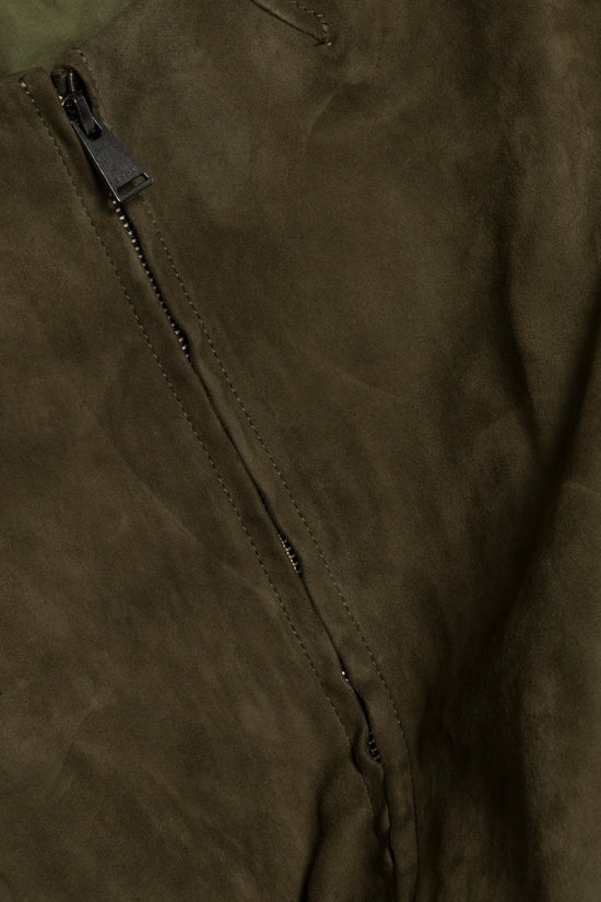 Olive green suede jacket with black metal zipper and studded pull detail.