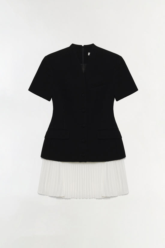 Black short-sleeve blazer top with white pleated mini skirt, button front, rear view.