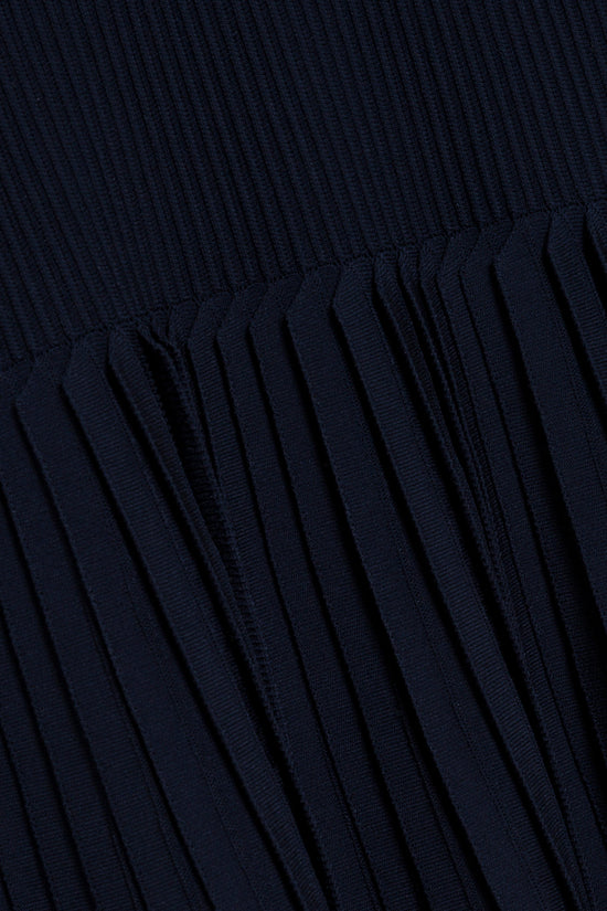 Dark navy ribbed knit mini dress with vertical pleated skirt detail.