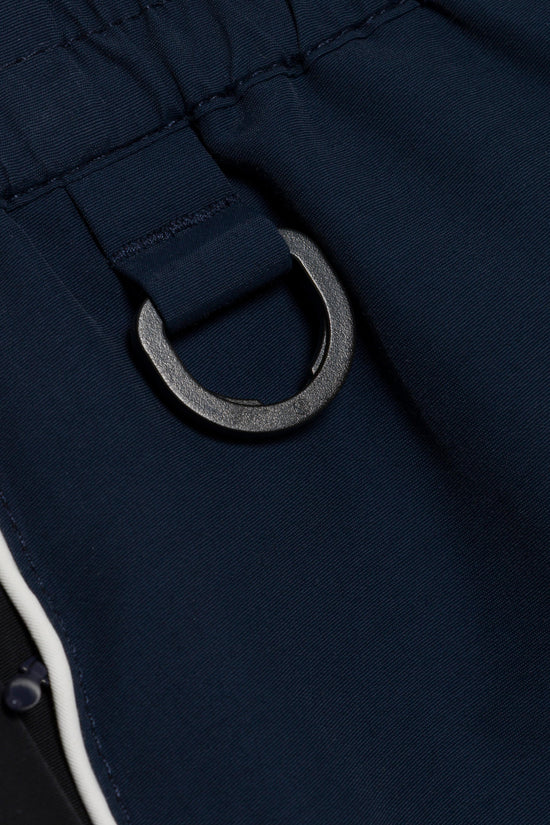 Navy cotton jogger with metal drawstring ring and white side stripe detail.