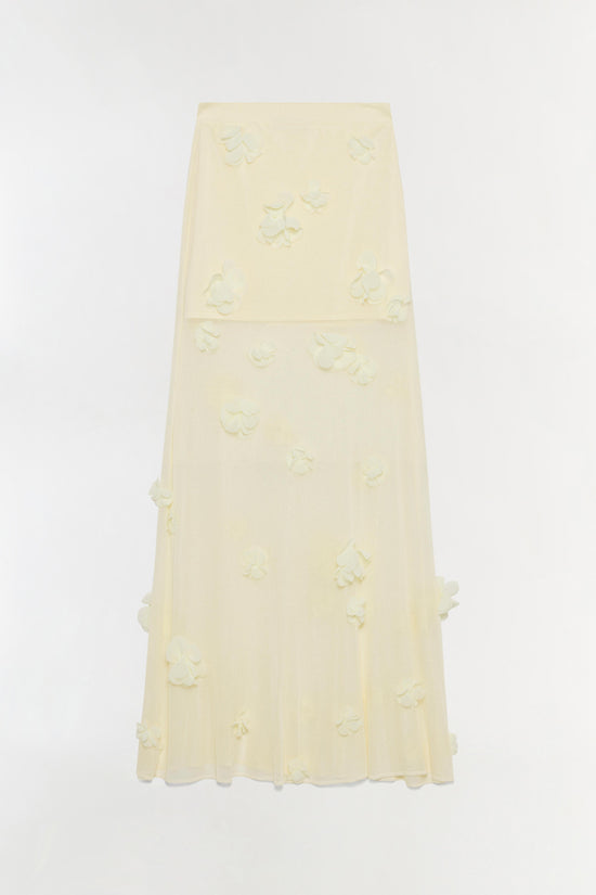 Cream midi skirt with textured floral appliqués scattered throughout and a tiered silhouette.