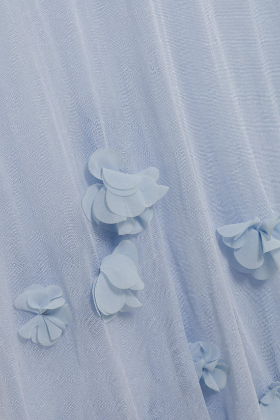 Light blue midi dress with three-dimensional white floral appliqués scattered across sheer fabric.