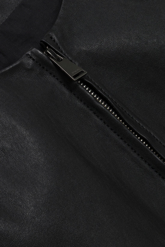 Black leather jacket with metal zipper and textured surface detail.
