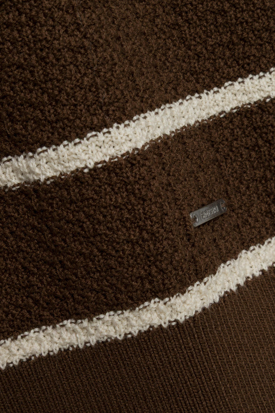 Brown boucle polo with diagonal cream stripes and brand label visible on chest.