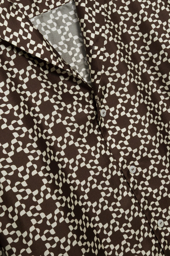 Brown and cream geometric printed silk shirt with button front closure and folded collar detail.