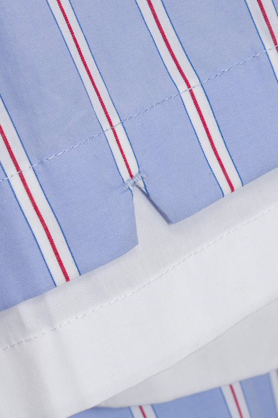 Light blue cotton fabric with vertical red and white stripes and white stitching detail.