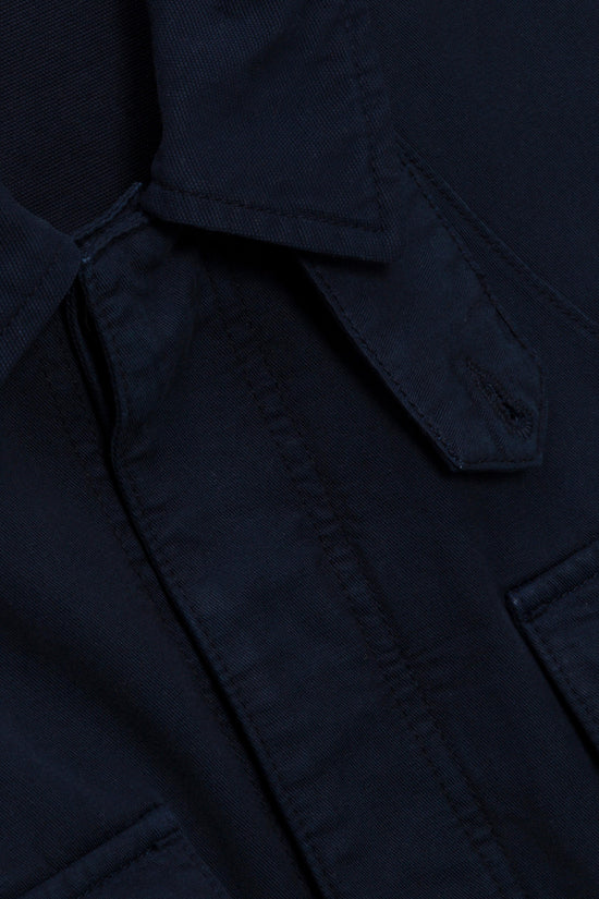 Navy utility jacket with visible chest pockets and textured fabric weave.