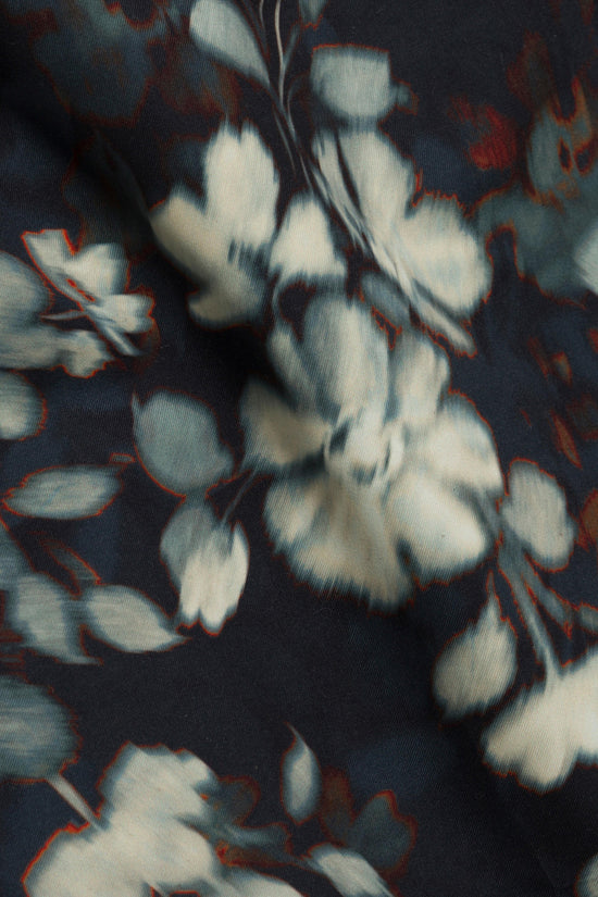 Malachi swim shorts with dark navy base, white and red floral print, and gray drawstring detail.