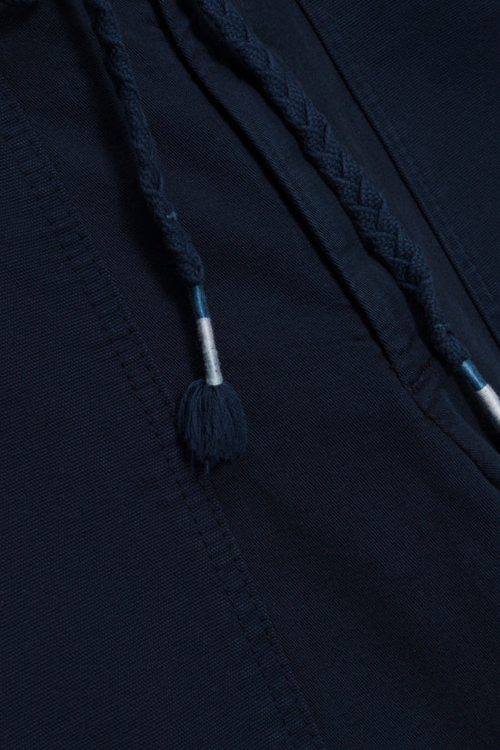 Navy utility pant with braided drawstring and tassel detail at waistband.