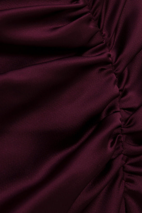 Deep burgundy satin fabric with ruched detailing on the side seam.