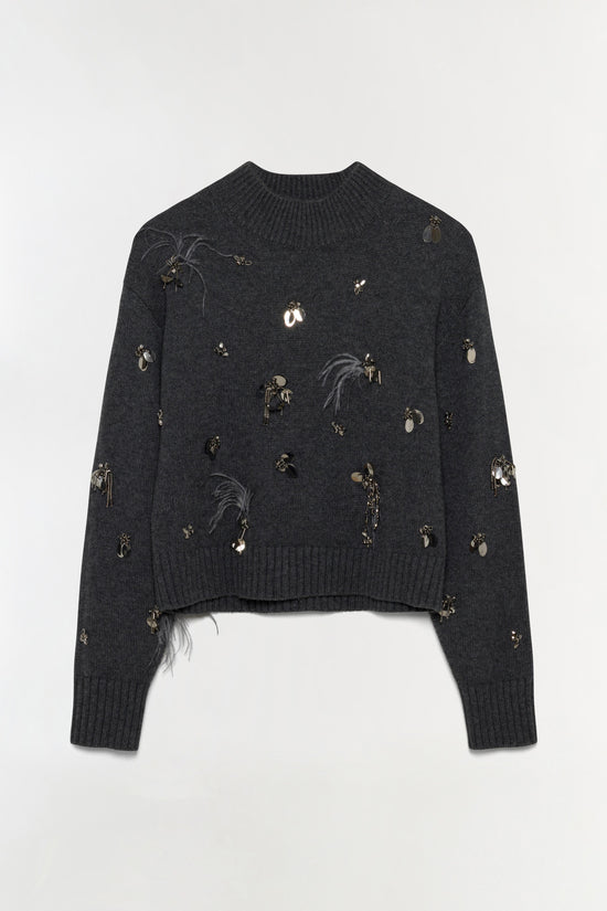 Charcoal gray sweater with scattered metallic charms and feather embellishments throughout.