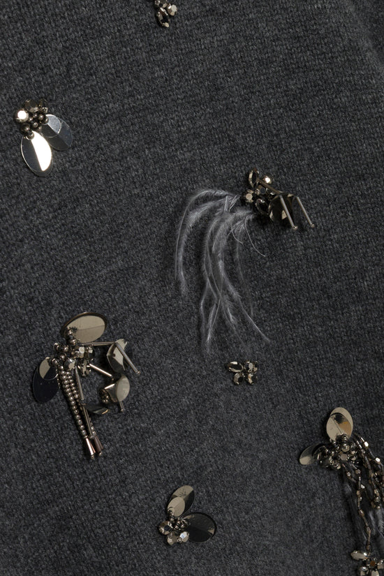 Charcoal knit sweater with scattered metallic embellishments including rhinestones, beads, and feather accents.