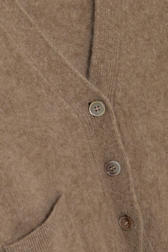 Beige brushed knit cardigan with four-hole buttons and ribbed trim detail shown in close-up view.