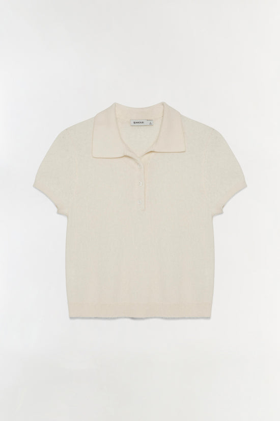 Cream-colored short-sleeve knit polo shirt with collared neckline and button front closure.