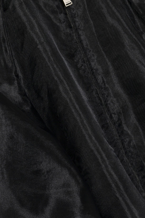 Black organza top with shimmering texture and center front seam detail.