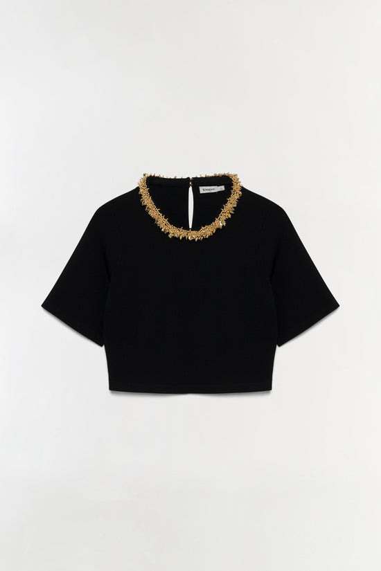 Black knit top with short sleeves and gold beaded neckline trim.