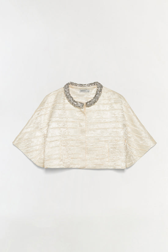 Cream satin cropped jacket with textured fabric and embellished silver collar detail.