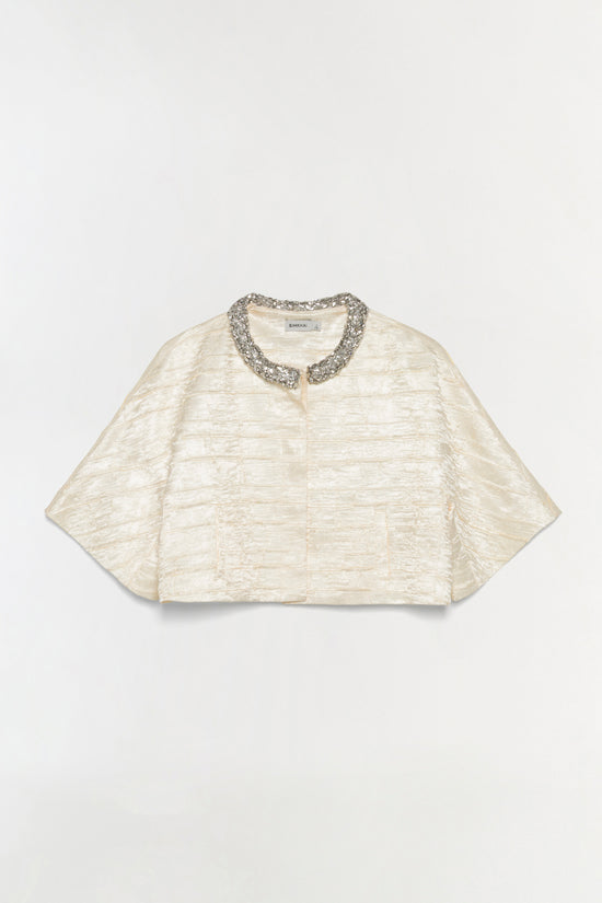 Cream satin cropped jacket with textured fabric and embellished silver collar detail.