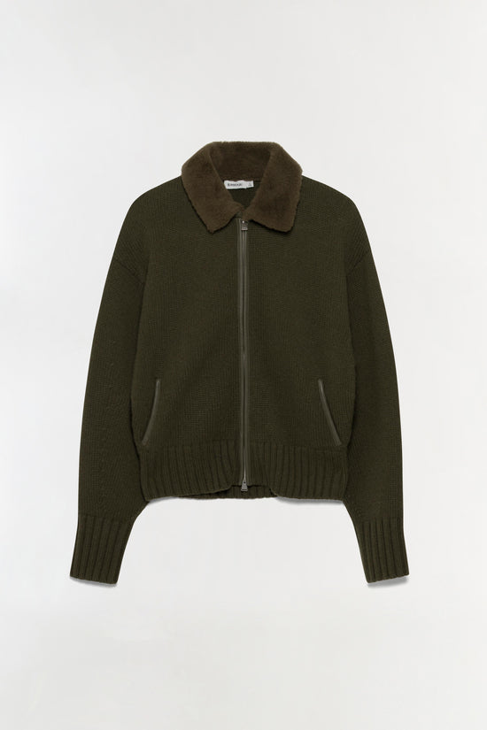 Olive green knit cardigan with textured collar, full-length sleeves, front zip closure, and side pockets.