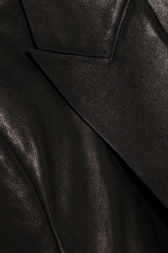 Black leather blazer with textured surface and tailored seaming detail.