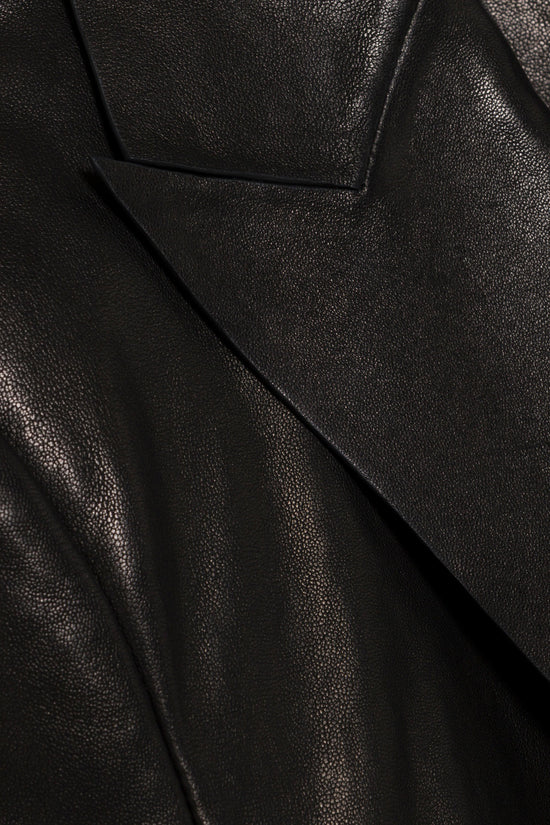 Black leather blazer with textured surface and tailored seaming detail.