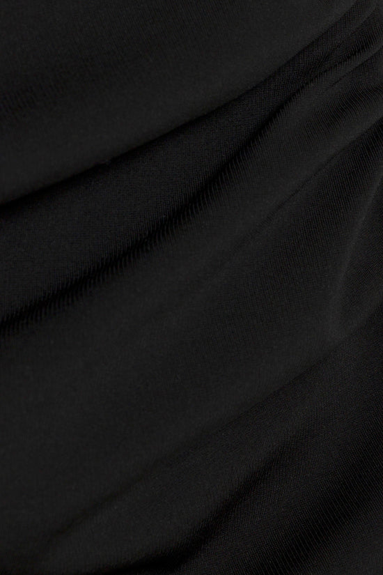 Black ribbed mini dress with draped fabric folds and texture detail.