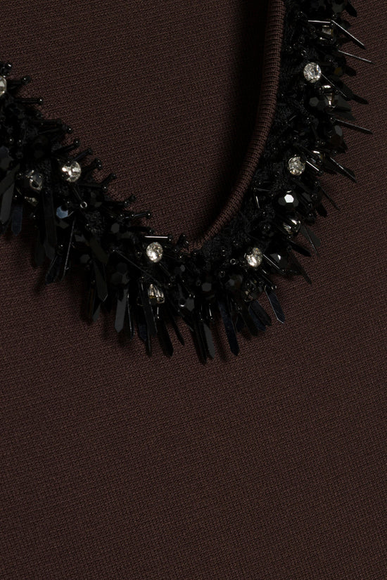 Brown knit mini dress with black embellished neckline featuring rhinestones and spikes.