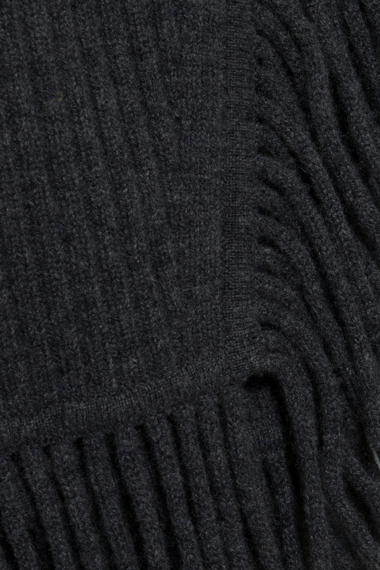 Charcoal knit dress with vertical ribbed texture and fringe trim at the hem.