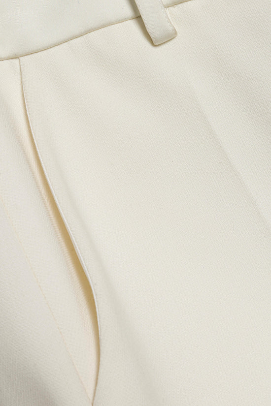 Cream straight leg pant with flat front seams and belt loops visible at waistband.