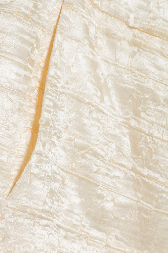Cream satin pant fabric with side seam and gold piping detail.