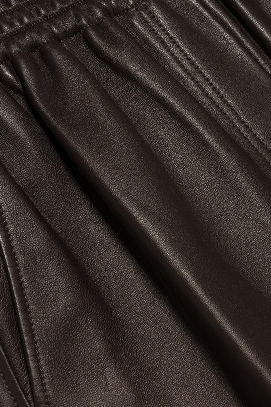 Black leather pant with textured surface and vertical seam details.