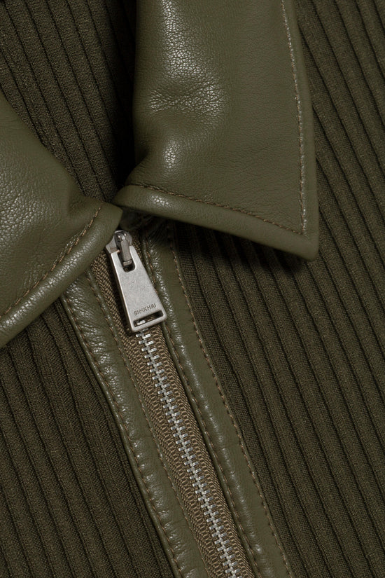 Olive green knit dress with leather collar and front zip closure detail.