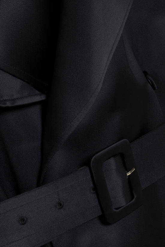 Black belted coat with rectangular buckle detail on waist and button closures.