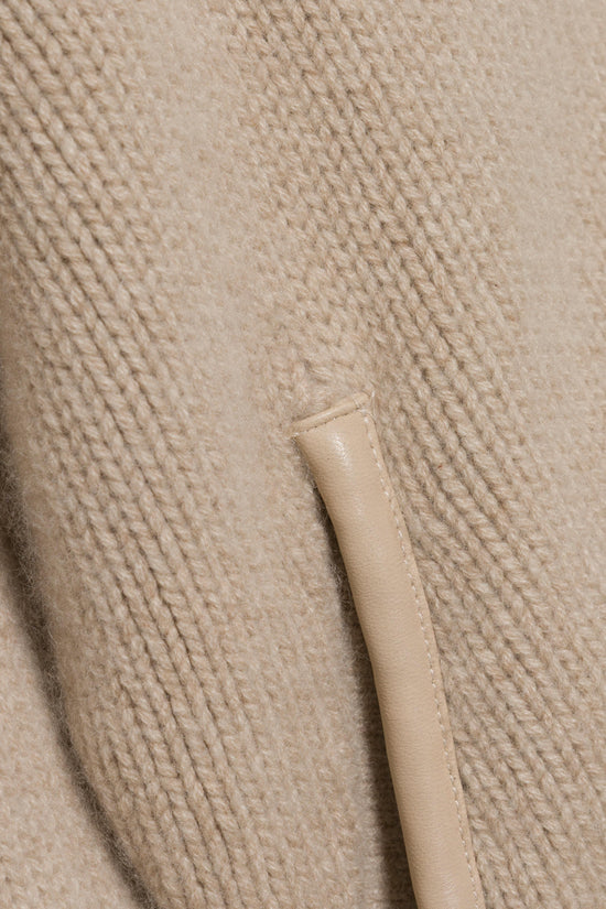Beige wool cashmere cardigan with textured knit fabric and front button closure detail.