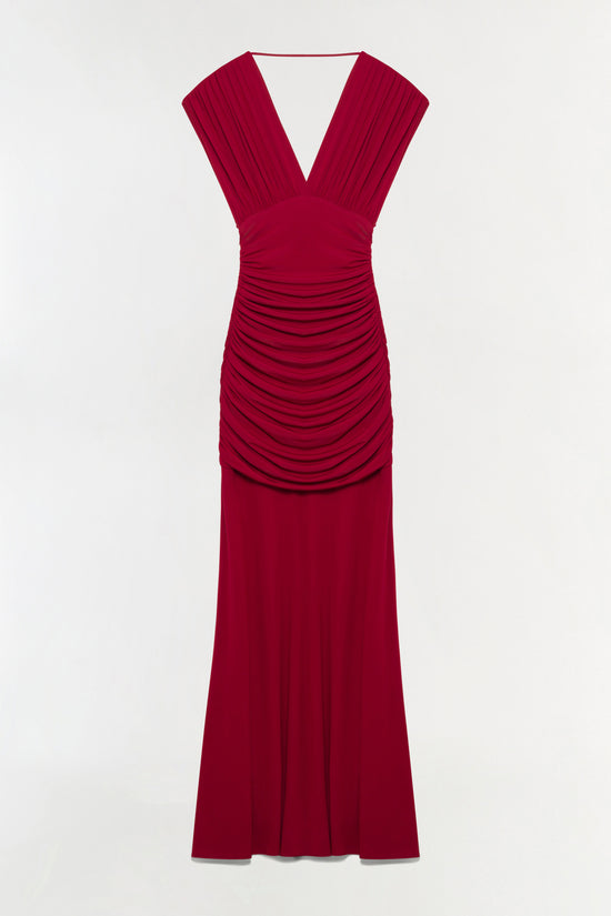 Deep red sleeveless draped jersey gown with deep V-neckline and ruched detailing at waist.