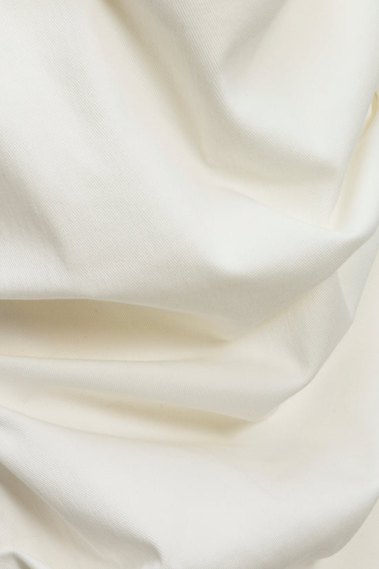 Cream ribbed fabric with gathered ruching detail on bustier top.